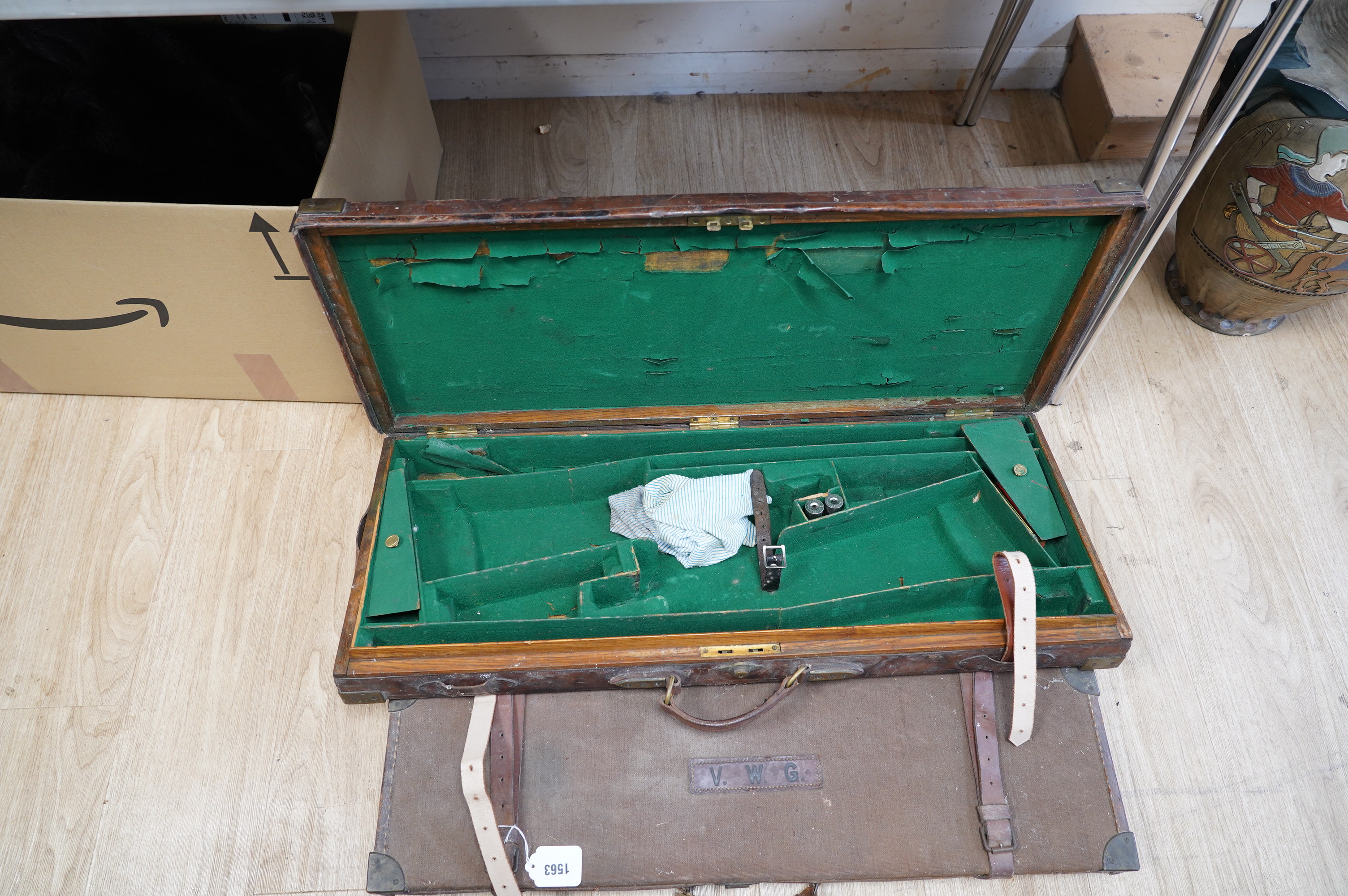 Two leather gun cases, largest 85cm wide, 34cm deep. Condition - fair considering age and use